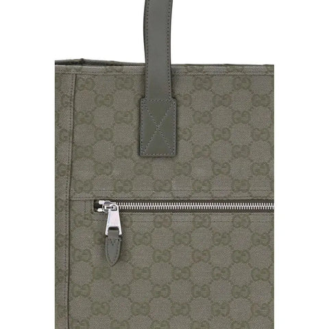 GG canvas medium Tote Bag featuring GG canvas design and a zippered pocket detail.